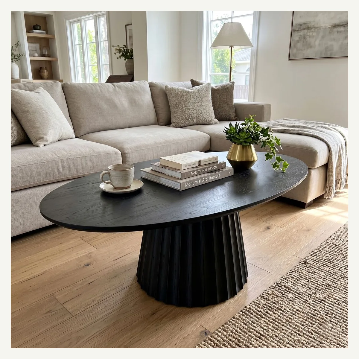 Black Oval Pedestal Coffee Table — living room setting